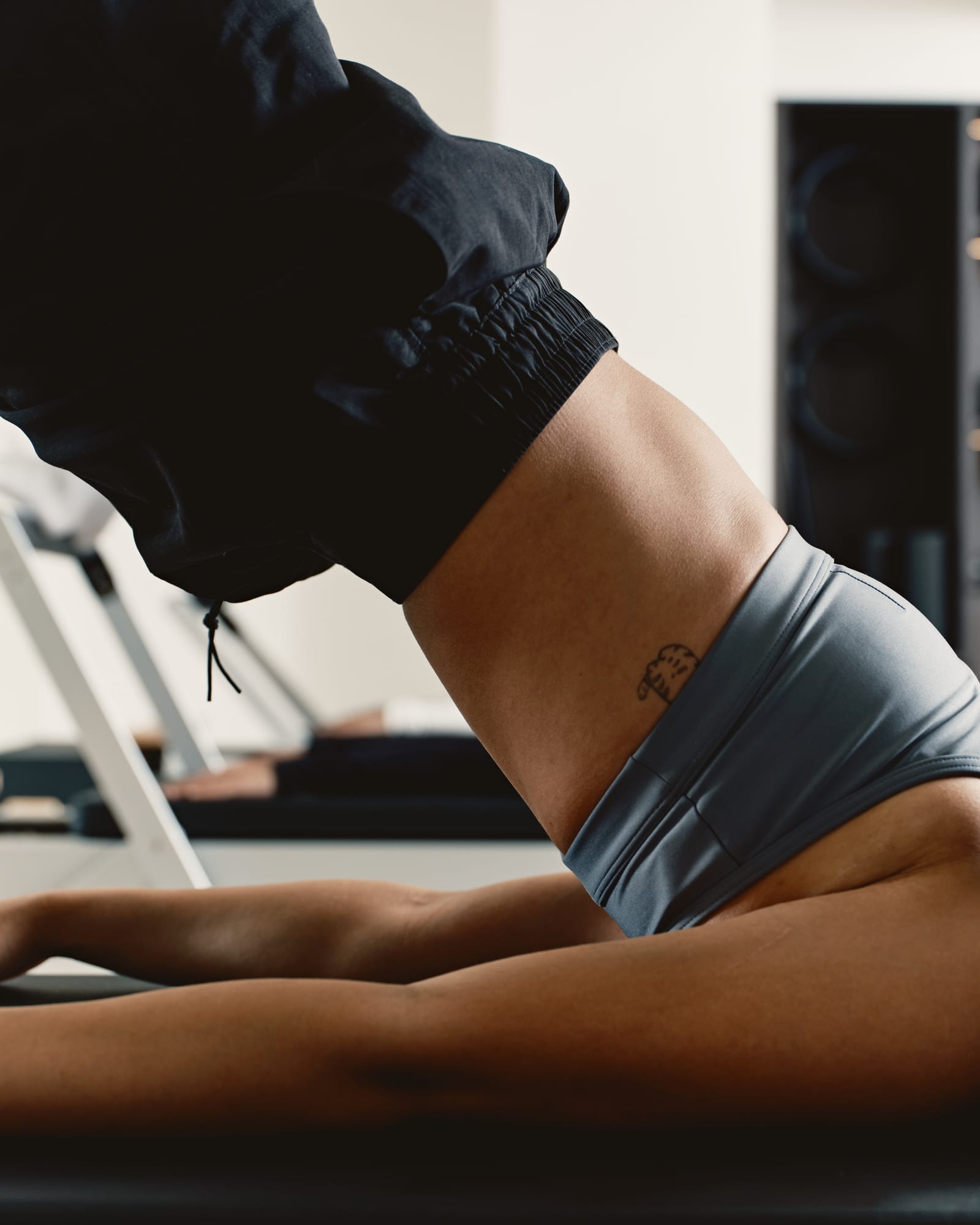 Client moving through a reformer exercise in the studio